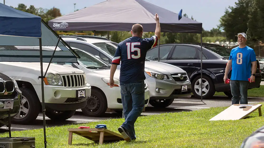 Playing cornhole at a tailgate party before the big game. 