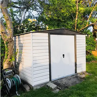 Cream-colored Arrow shed in a backyard