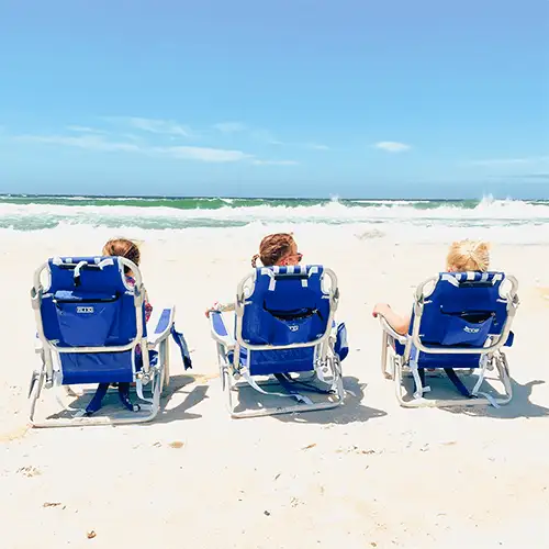 3 people sitting in beach chairs